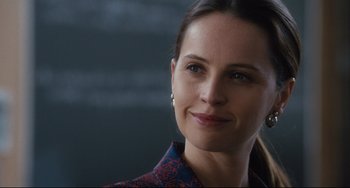Movie still from “On the Basis of Sex” (2018), directed by Mimi Leder – A person smiling for the camera; Close Up shot, Over the shoulder angle