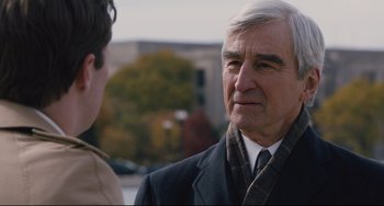 Movie still from “On the Basis of Sex” (2018), directed by Mimi Leder – An older man wearing a suit and tie talking to a young man; Close Up shot, Over the shoulder angle