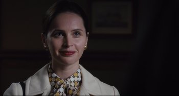 Movie still from “On the Basis of Sex” (2018), directed by Mimi Leder – A person wearing a suit and tie; Close Up shot, Over the shoulder angle