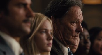 Movie still from “On the Basis of Sex” (2018), directed by Mimi Leder – A group of people standing next to each other in a room; Close Up shot, Low angle