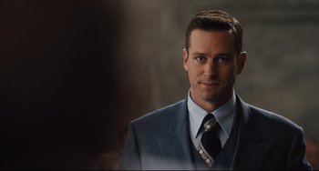 Movie still from “On the Basis of Sex” (2018), directed by Mimi Leder – A person wearing a suit and tie; Close Up shot, Over the shoulder angle