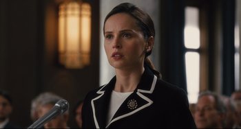 Movie still from “On the Basis of Sex” (2018), directed by Mimi Leder – A woman wearing a black and white jacket; Close Up shot, Over the shoulder angle