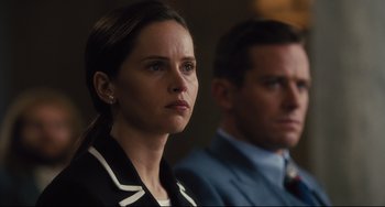 Movie still from “On the Basis of Sex” (2018), directed by Mimi Leder – A woman and a man sitting next to each other in a room; Close Up shot, Over the shoulder angle