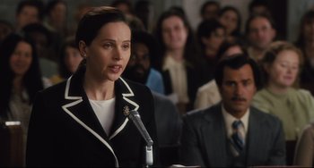Movie still from “On the Basis of Sex” (2018), directed by Mimi Leder – A woman is speaking at a podium in front of a crowd; Close Up shot, Over the shoulder angle
