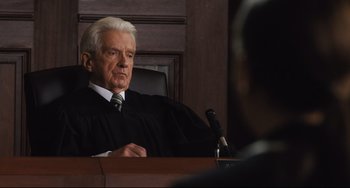 Movie still from “On the Basis of Sex” (2018), directed by Mimi Leder – An older man in a court room wearing a judge's robe; Close Up shot, Low angle