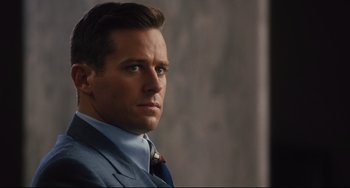 Movie still from “On the Basis of Sex” (2018), directed by Mimi Leder – A person wearing a suit and tie; Close Up shot, Over the shoulder angle