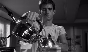 Movie still from “On the Beach” (1959), directed by Stanley Kramer – A man pouring tea into a tea pot; Close Up shot, Low angle