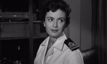 Movie still from “On the Beach” (1959), directed by Stanley Kramer – An old photo of a woman wearing a uniform; Close Up shot, Low angle