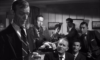 Movie still from “On the Beach” (1959), directed by Stanley Kramer – A black and white photo of a group of people smoking; Medium shot, Over the shoulder angle