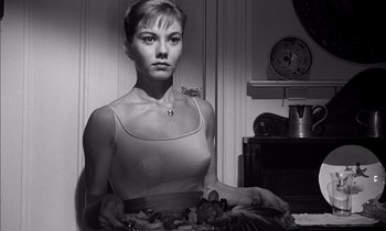 Movie still from “On the Beach” (1959), directed by Stanley Kramer – A black and white photo of a woman holding a bowl of fruit; Close Up shot, Low angle