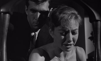 Movie still from “On the Beach” (1959), directed by Stanley Kramer – A man and a woman in a black and white photo; Close Up shot, Low angle