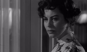 Movie still from “On the Beach” (1959), directed by Stanley Kramer – Black and white photograph of a woman looking at the camera; Close Up shot, Over the shoulder angle