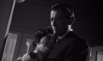 Movie still from “On the Beach” (1959), directed by Stanley Kramer – A man and a woman are posing for a picture; Close Up shot, Low angle