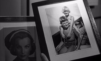 Movie still from “On the Beach” (1959), directed by Stanley Kramer – An old photo of two children in a bathing suit; Extreme Close Up shot, High angle