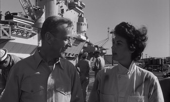 Movie still from “On the Beach” (1959), directed by Stanley Kramer – A man and a woman standing next to each other on a boat; Close Up shot, Low angle