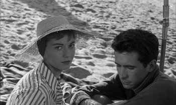 Movie still from “On the Beach” (1959), directed by Stanley Kramer – A man and a woman sitting on the beach; Close Up shot, High angle