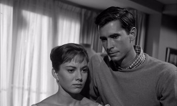 Movie still from “On the Beach” (1959), directed by Stanley Kramer – A man and a woman posing for a picture; Close Up shot, Low angle