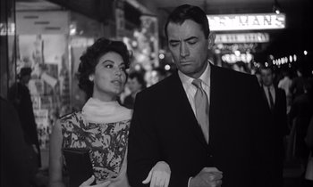 Movie still from “On the Beach” (1959), directed by Stanley Kramer – A man and a woman standing next to each other; Medium shot, Low angle