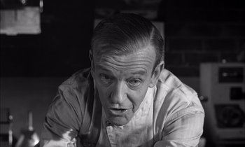 Movie still from “On the Beach” (1959), directed by Stanley Kramer – An older man is looking at the camera; Close Up shot, Low angle