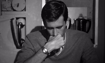 Movie still from “On the Beach” (1959), directed by Stanley Kramer – A young man is sitting in front of a coffee pot; Close Up shot, High angle
