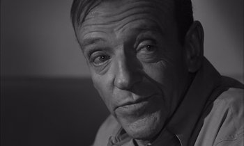 Movie still from “On the Beach” (1959), directed by Stanley Kramer – An older man is looking at the camera; Close Up shot, High angle