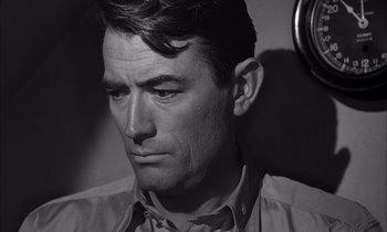 Movie still from “On the Beach” (1959), directed by Stanley Kramer – Black and white photograph of a man looking sad; Close Up shot, High angle