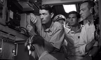 Movie still from “On the Beach” (1959), directed by Stanley Kramer – A black - and - white photo of three men in uniform; Medium shot, Low angle