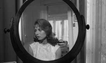 Movie still from “On the Beach” (1959), directed by Stanley Kramer – A black and white photo of a woman looking in a mirror; Close Up shot, Over the shoulder angle
