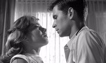 Movie still from “On the Beach” (1959), directed by Stanley Kramer – A man and a woman looking at each other in front of a window; Close Up shot, Low angle