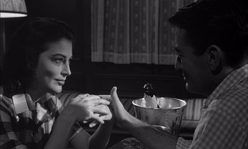 Movie still from “On the Beach” (1959), directed by Stanley Kramer – A man and a boy sitting in front of each other; Close Up shot, High angle