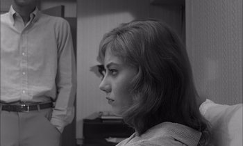 Movie still from “On the Beach” (1959), directed by Stanley Kramer – A black - and - white photo of a woman looking at the camera; Close Up shot, Over the shoulder angle