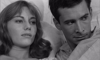 Movie still from “On the Beach” (1959), directed by Stanley Kramer – A man and a woman sitting next to each other; Close Up shot, High angle