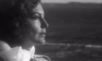 Movie still from “On the Beach” (1959), directed by Stanley Kramer – An old black and white photo of a woman's face; Close Up shot, Over the shoulder angle