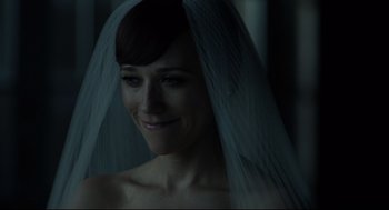 Movie still from “On the Rocks” (2020), directed by Sofia Coppola – A woman wearing a veil and smiling for the camera; Close Up shot, Over the shoulder angle