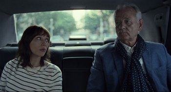Movie still from “On the Rocks” (2020), directed by Sofia Coppola – A man and a woman sitting in the back of a car; Close Up shot, Over the shoulder angle