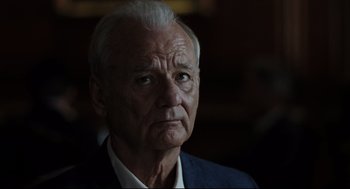 Movie still from “On the Rocks” (2020), directed by Sofia Coppola – An older man in a white shirt and a blue jacket; Close Up shot, Over the shoulder angle