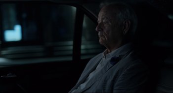 Movie still from “On the Rocks” (2020), directed by Sofia Coppola – An older man sitting in the back seat of a car; Close Up shot, Over the shoulder angle