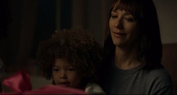 Movie still from “On the Rocks” (2020), directed by Sofia Coppola – A woman and a child are looking at something on a table; Close Up shot, Over the shoulder angle