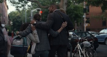 Movie still from “On the Rocks” (2020), directed by Sofia Coppola – A group of people standing next to each other on a street; Wide shot, Low angle