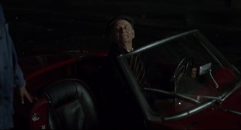 Movie still from “On the Rocks” (2020), directed by Sofia Coppola – An older man sitting in the driver's seat of an old car; Medium shot, High angle
