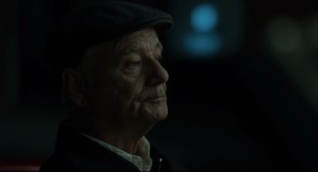 Movie still from “On the Rocks” (2020), directed by Sofia Coppola – An old man wearing a hat looking to his left; Close Up shot, Over the shoulder angle