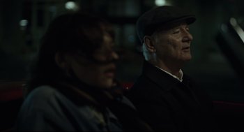 Movie still from “On the Rocks” (2020), directed by Sofia Coppola – An older man and a younger woman are looking at something; Close Up shot, Over the shoulder angle