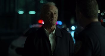 Movie still from “On the Rocks” (2020), directed by Sofia Coppola – An older man standing in the street at night; Close Up shot, Over the shoulder angle
