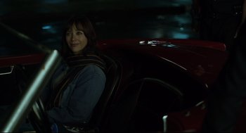 Movie still from “On the Rocks” (2020), directed by Sofia Coppola – A woman sitting in the driver's seat of a red car; Medium shot, Over the shoulder angle