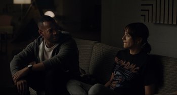Movie still from “On the Rocks” (2020), directed by Sofia Coppola – A man and a woman sitting on a couch talking; Medium shot, Over the shoulder angle