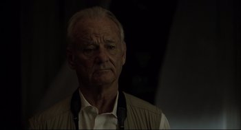 Movie still from “On the Rocks” (2020), directed by Sofia Coppola – An older man wearing a white shirt and a brown vest; Close Up shot, Low angle