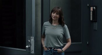 Movie still from “On the Rocks” (2020), directed by Sofia Coppola – A woman standing in front of a building with her hands in her pockets; Medium shot, Over the shoulder angle