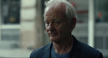 Movie still from “On the Rocks” (2020), directed by Sofia Coppola – An older man with white hair looking to his left; Close Up shot, Over the shoulder angle