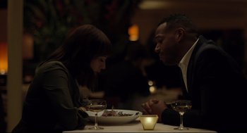 Movie still from “On the Rocks” (2020), directed by Sofia Coppola – A man and a woman sitting at a table with a plate of food; Medium shot, Over the shoulder angle