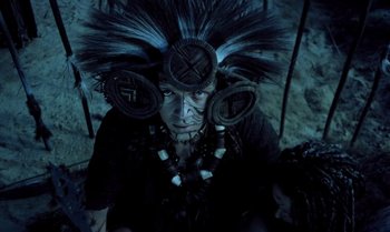 A person with a headdress and a necklace